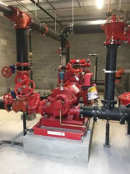 Red commercial fire pump installed on a concrete pad