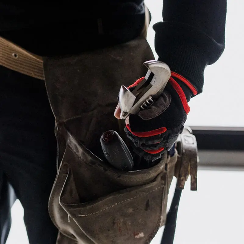 Tradesperson wearing a leather tool belt